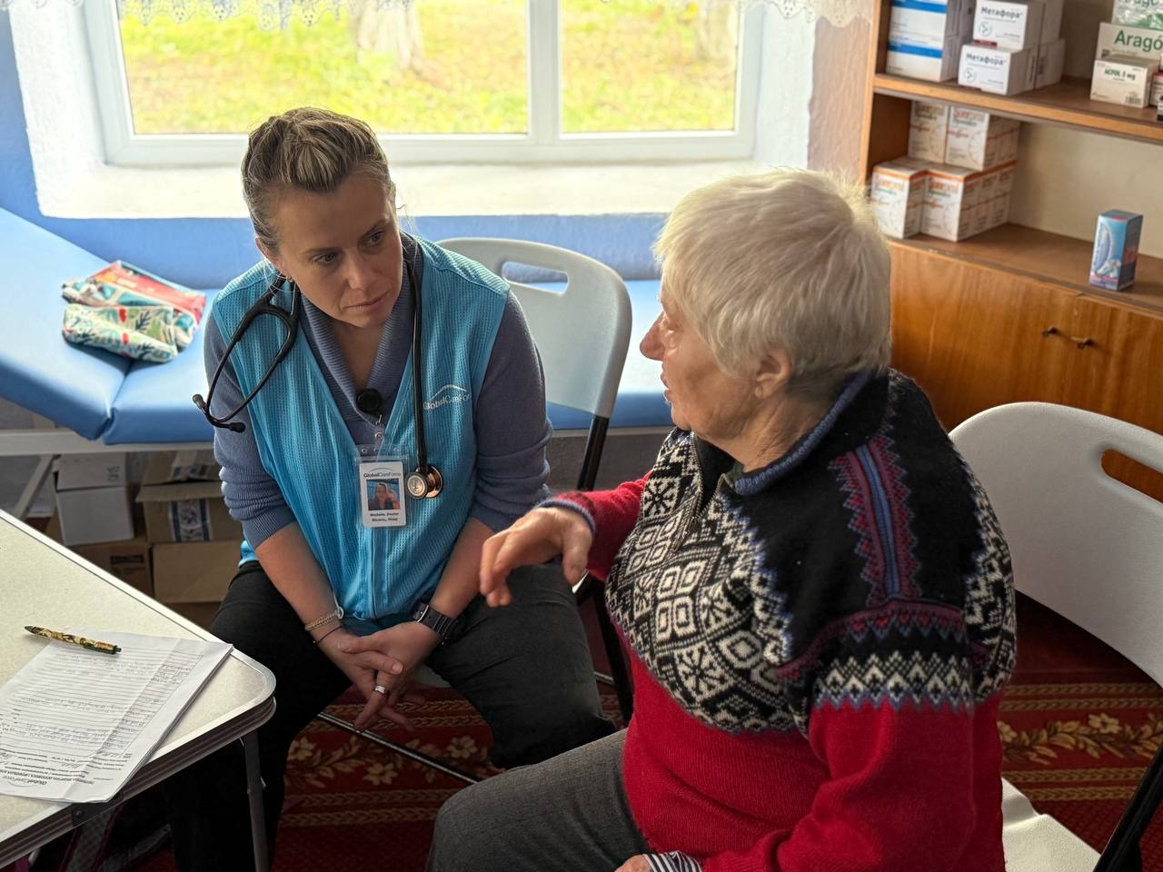 A GCF clinician listens to a patient during a consultation.